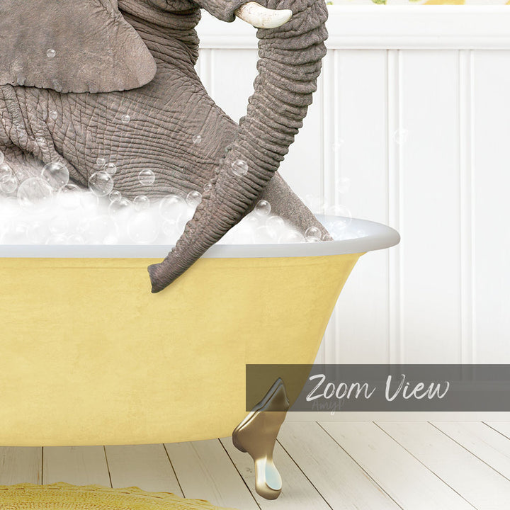A large gray elephant is sitting in a yellow bathtub filled with bubbles, with a white wall and wooden floor in the background.