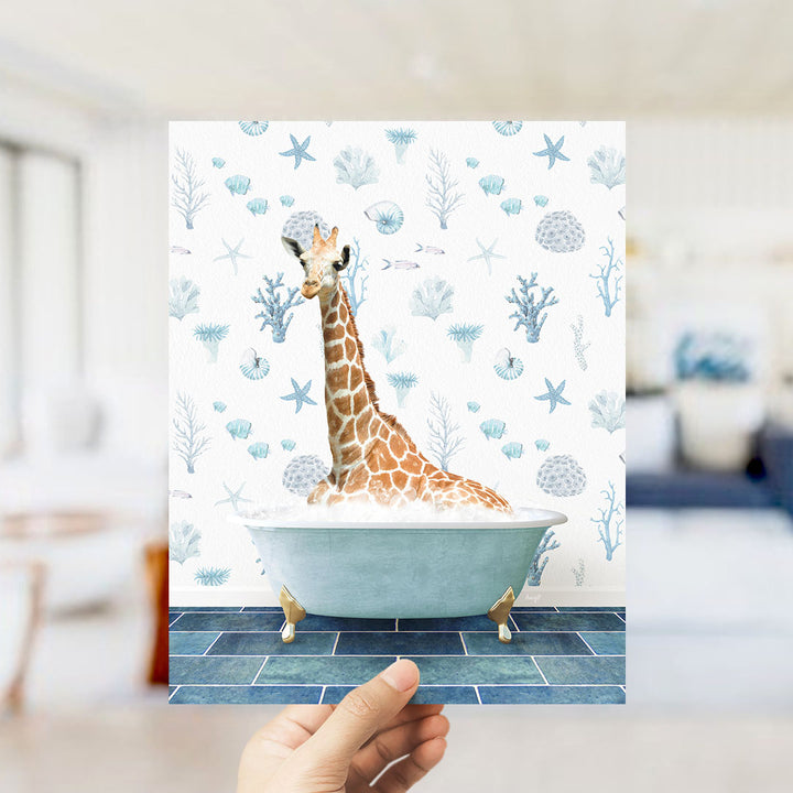 A giraffe sitting in a bathtub filled with bubbles, surrounded by a blue and white ocean-themed wallpaper.