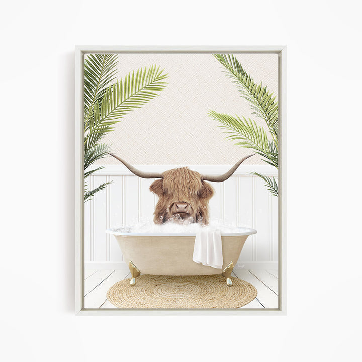 A brown cow with long horns is sitting in a white bathtub filled with water, surrounded by green palm leaves.