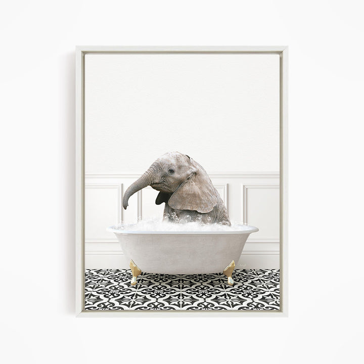 A baby elephant sitting in a white bathtub filled with water, surrounded by a black and white patterned floor.