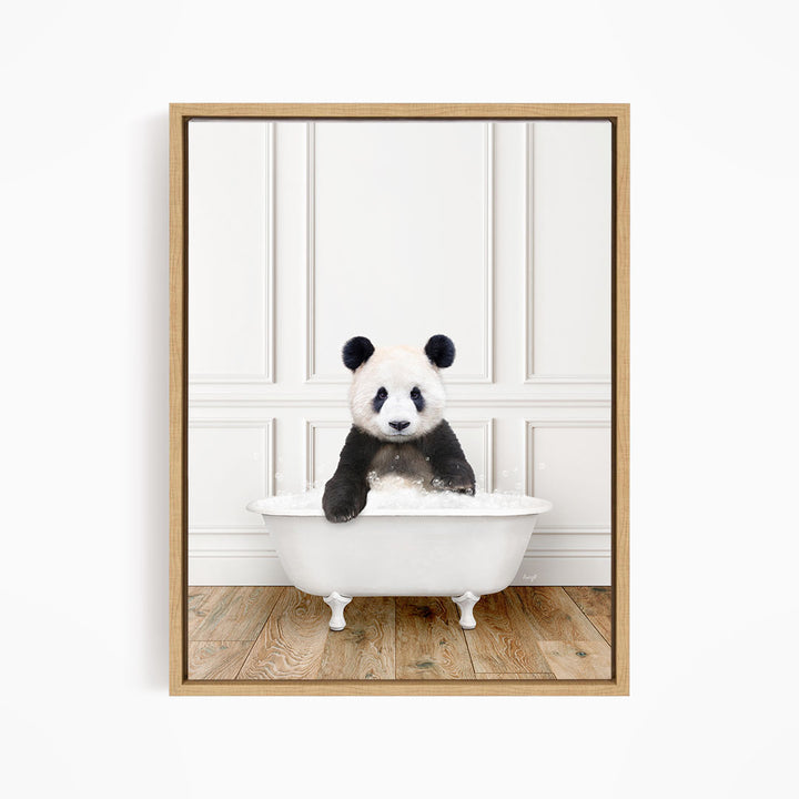 A panda bear sitting in a white bathtub, surrounded by a wooden floor and white walls.