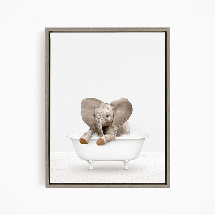 A baby elephant sitting in a white bathtub, with its trunk raised and ears spread out.
