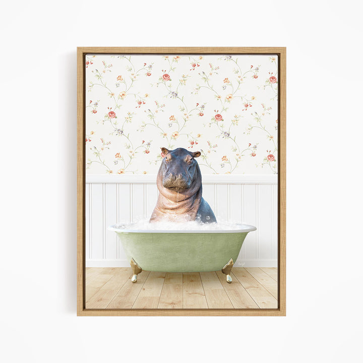 A hippopotamus sitting in a green bathtub filled with water, surrounded by a floral wallpaper.