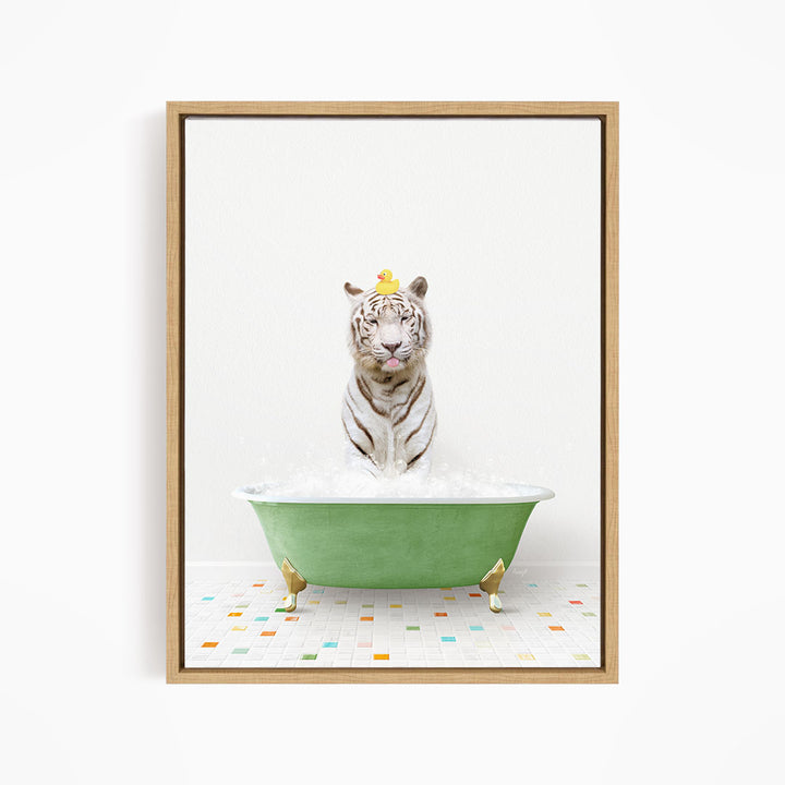A white tiger is sitting in a green bathtub filled with bubbles, with a yellow duck perched on its head.