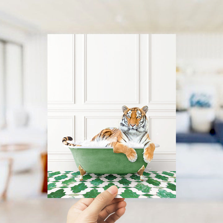 A tiger is sitting in a green bathtub, surrounded by a patterned floor and a white wall.
