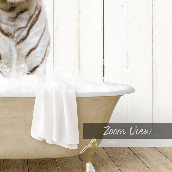 A white cat sitting in a bathtub filled with bubbles, with a towel draped over the side and a "Zoom View" label below the image.