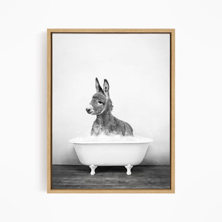 A donkey is sitting in a bathtub filled with water, creating a whimsical and playful scene.