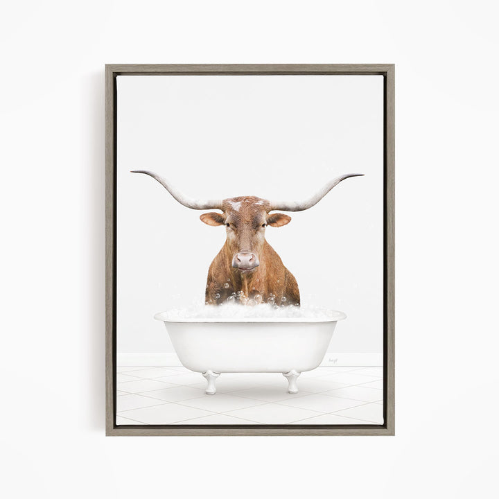 A brown steer with long horns is standing in a white bathtub filled with water, creating a whimsical and humorous scene.