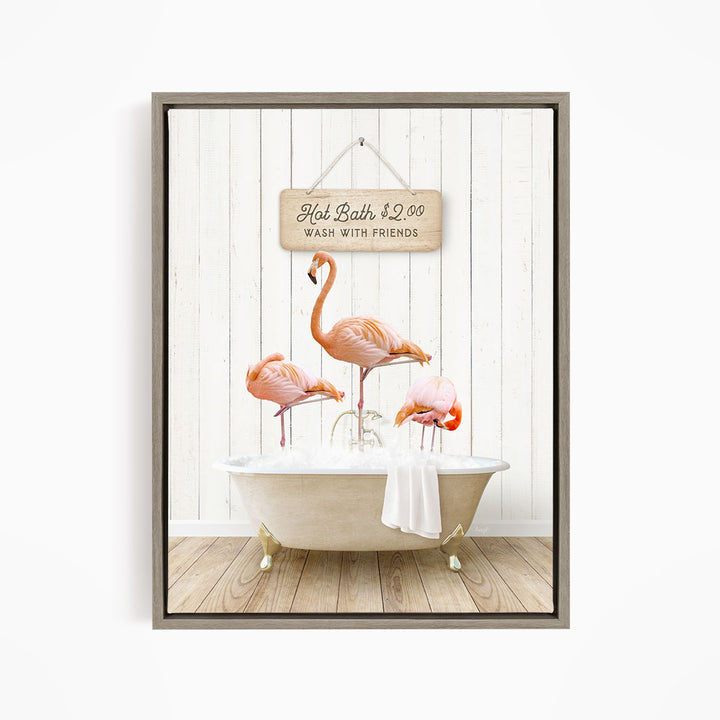 A framed image depicting three flamingos standing in a bathtub, with a sign above them that reads "Hot Bath $2.00 WASH WITH FRIENDS".