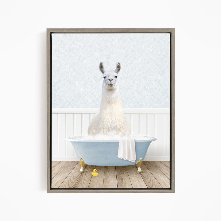 A white llama sitting in a blue bathtub filled with bubbles, with a yellow rubber duck floating nearby.