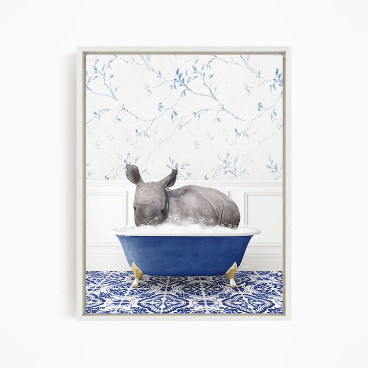 A rhinoceros is sitting in a blue bathtub filled with water, surrounded by a blue and white patterned floor.