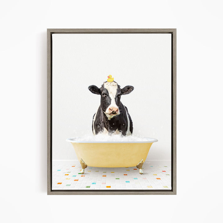 A black and white cow is standing in a yellow bathtub filled with water, with a rubber duck perched on its head.