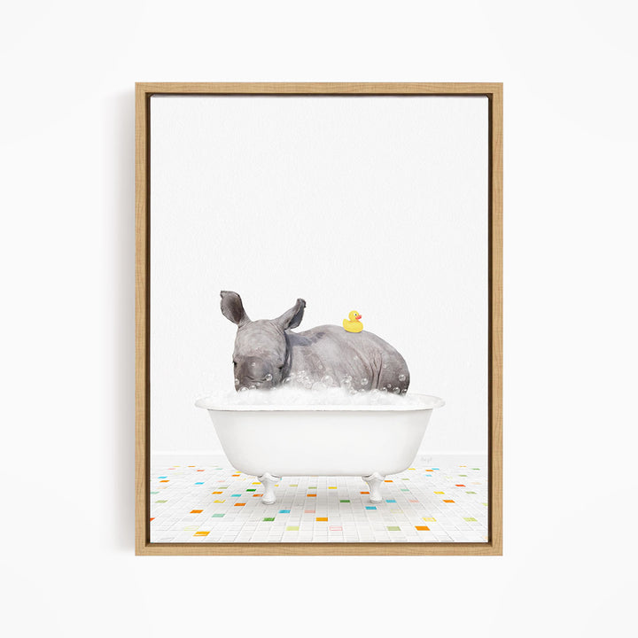 A rhinoceros is sitting in a white bathtub filled with water, with a yellow rubber duck floating on its back.
