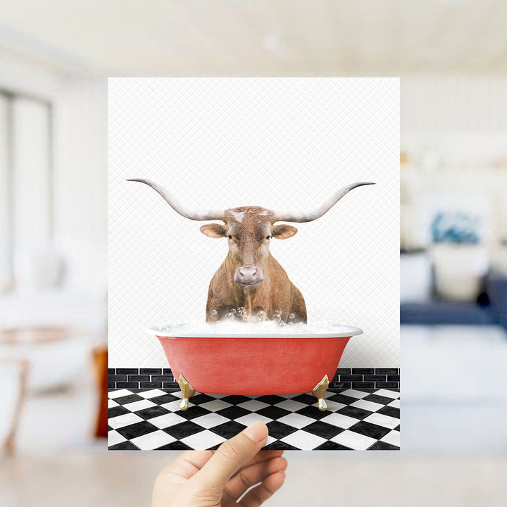 A brown bull with long horns is sitting in a red bathtub filled with water, creating a whimsical and humorous scene.