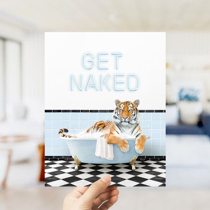 A hand holding a card with a tiger sitting in a bathtub, with the text "GET NAKED" written on it.