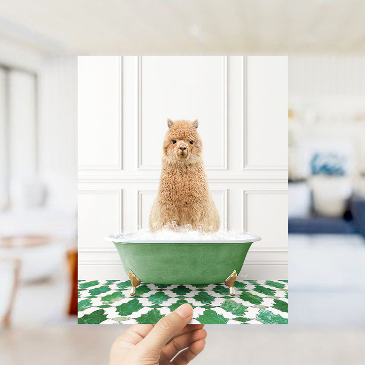 A fluffy brown alpaca sitting in a green bathtub filled with bubbles, surrounded by a patterned green and white floor.