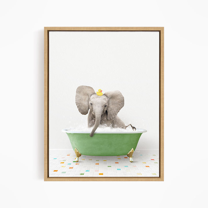 A gray elephant is sitting in a green bathtub filled with water, with a yellow rubber duck floating on its head.