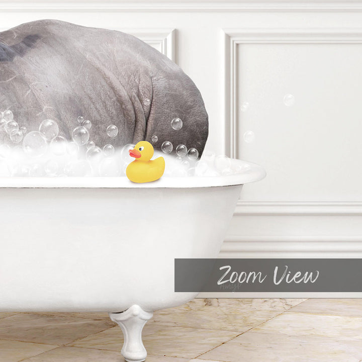 A white bathtub filled with bubbles, with a yellow rubber duck sitting in the water.