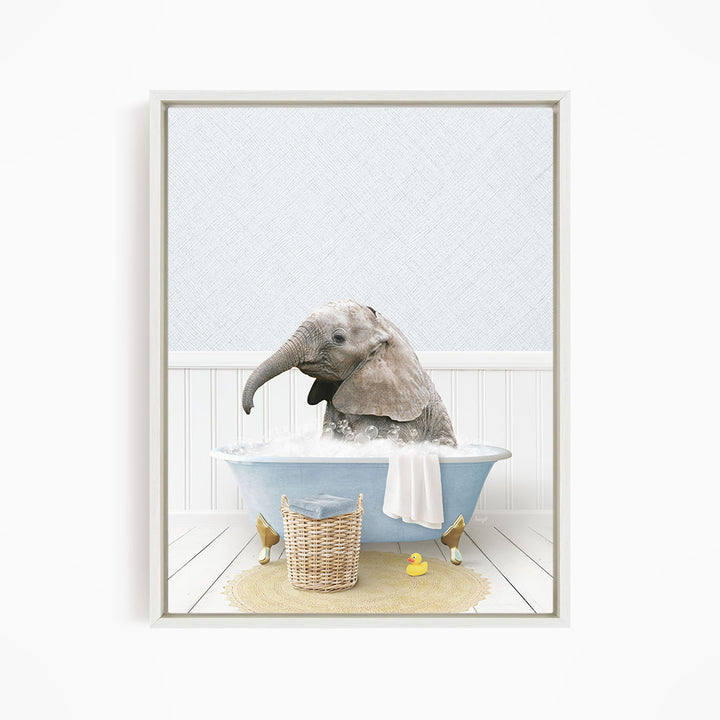 A baby elephant sitting in a blue bathtub filled with water, surrounded by a yellow rubber duck and a wicker basket.