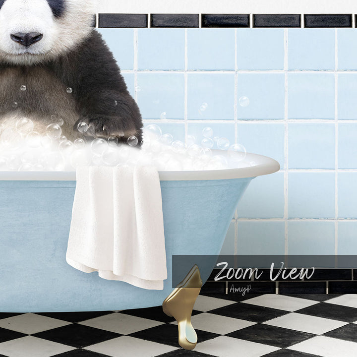 A panda bear sitting in a blue bathtub filled with bubbles, with a towel and gold bathtub leg visible.