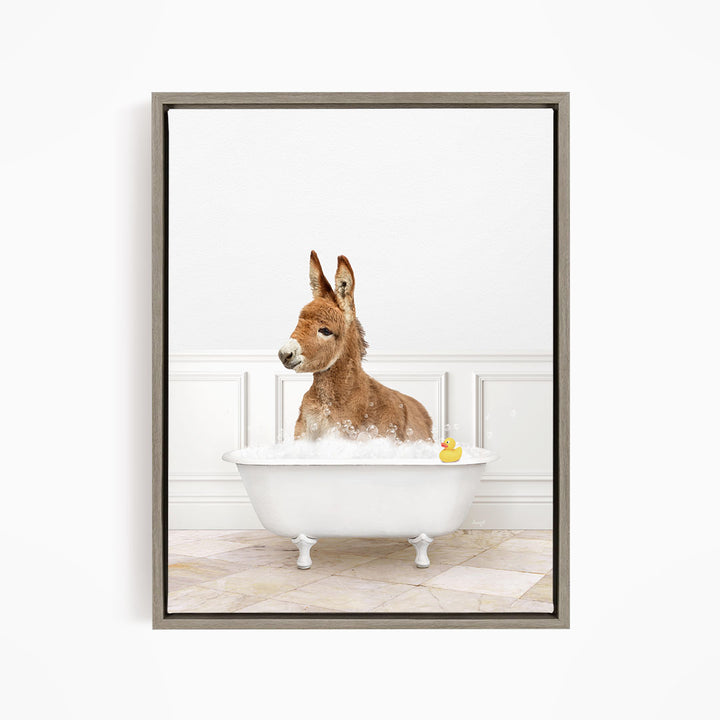 A donkey is sitting in a white bathtub filled with water, with a rubber duck floating in the tub.
