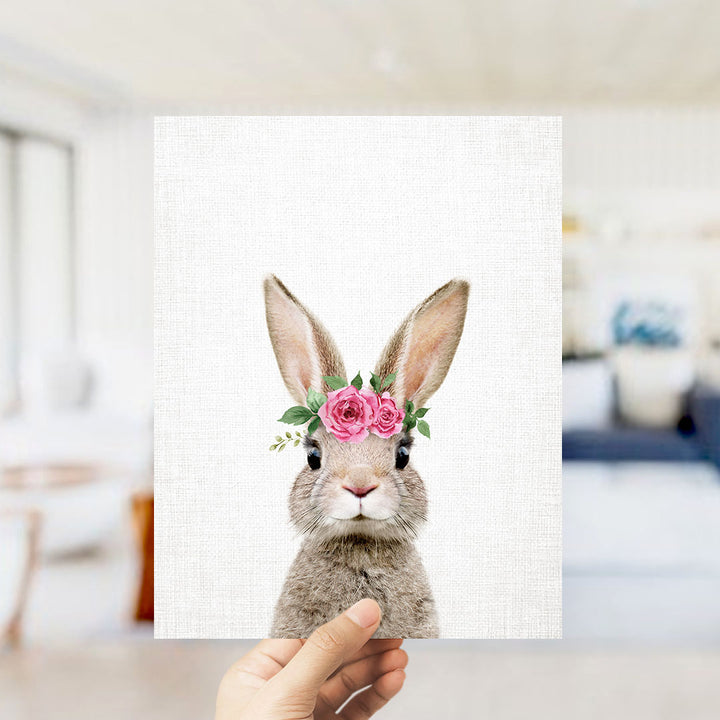 A hand is holding up a square print featuring a cute rabbit wearing a pink flower crown.
