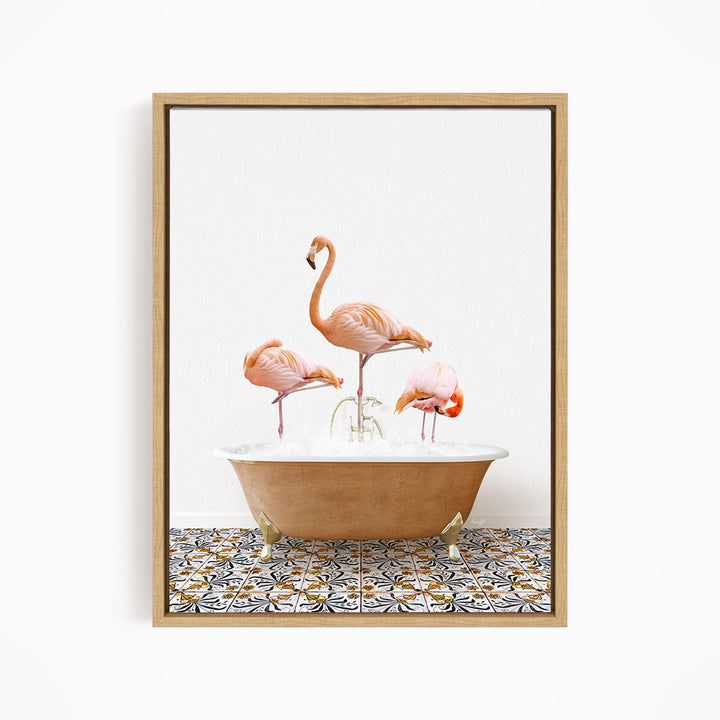 A framed image depicting three pink flamingos standing in a bathtub filled with water, with a patterned tile floor beneath.