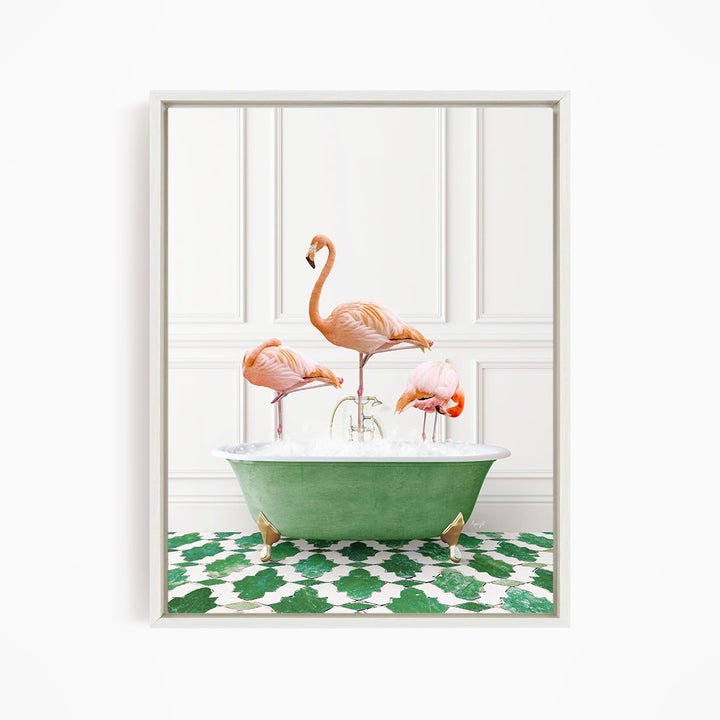 A framed image depicting three pink flamingos standing in a green bathtub filled with water, with a green and white patterned floor beneath.