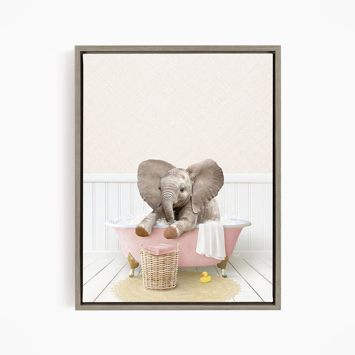 A gray elephant sitting in a pink bathtub, surrounded by a yellow rubber duck and a white towel.