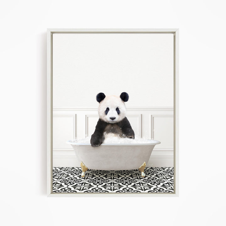 A panda bear sitting in a white bathtub filled with bubbles, surrounded by a black and white patterned floor.