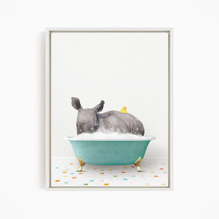 A rhinoceros is sitting in a blue bathtub filled with bubbles, with a yellow rubber duck floating on its back.