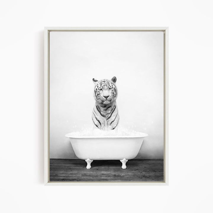 A black and white photograph of a tiger sitting in a bathtub filled with water.