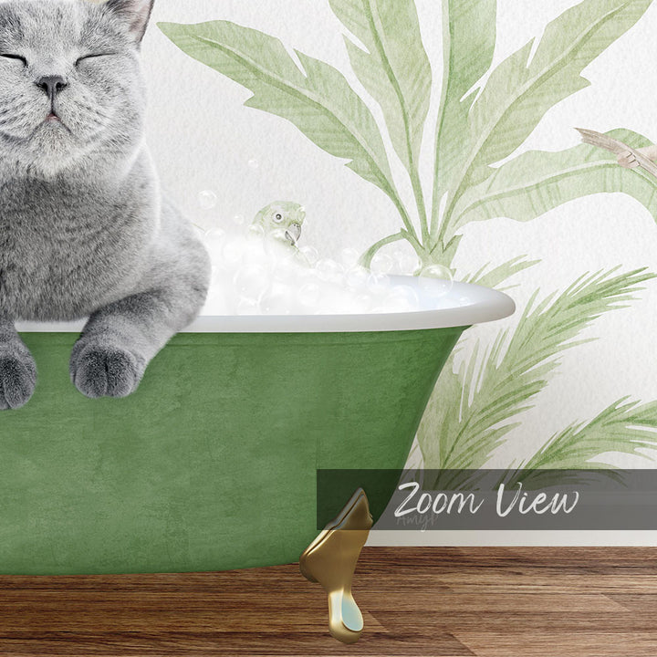 A gray cat sitting in a green bathtub, with a bird bath and palm leaves in the background.