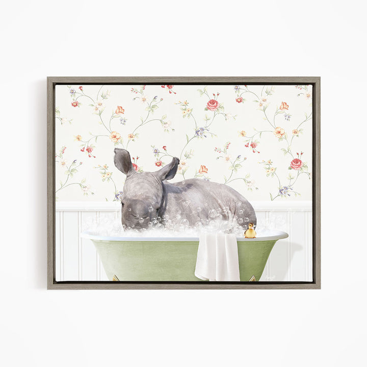 A rhinoceros is sitting in a green bathtub filled with bubbles, surrounded by a floral wallpaper.