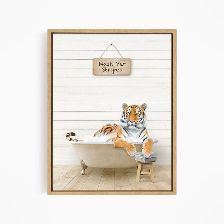 A tiger is sitting in a bathtub, with a sign above it that says "Wash Yer Stripes".