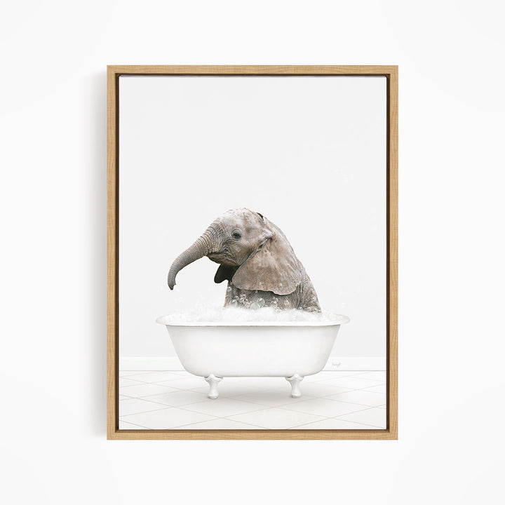 A baby elephant sitting in a white bathtub filled with water, appearing to enjoy the bath.