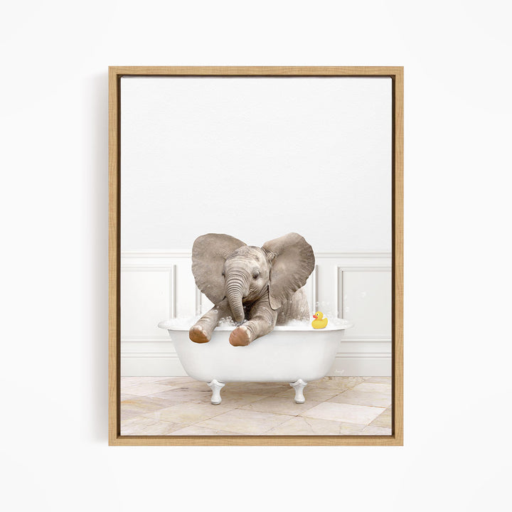 A baby elephant sitting in a white bathtub, with a rubber duck floating in the water.