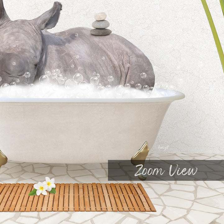 A rhinoceros is taking a bath in a white bathtub, surrounded by bubbles, with a wooden mat and a stone stack on the floor.