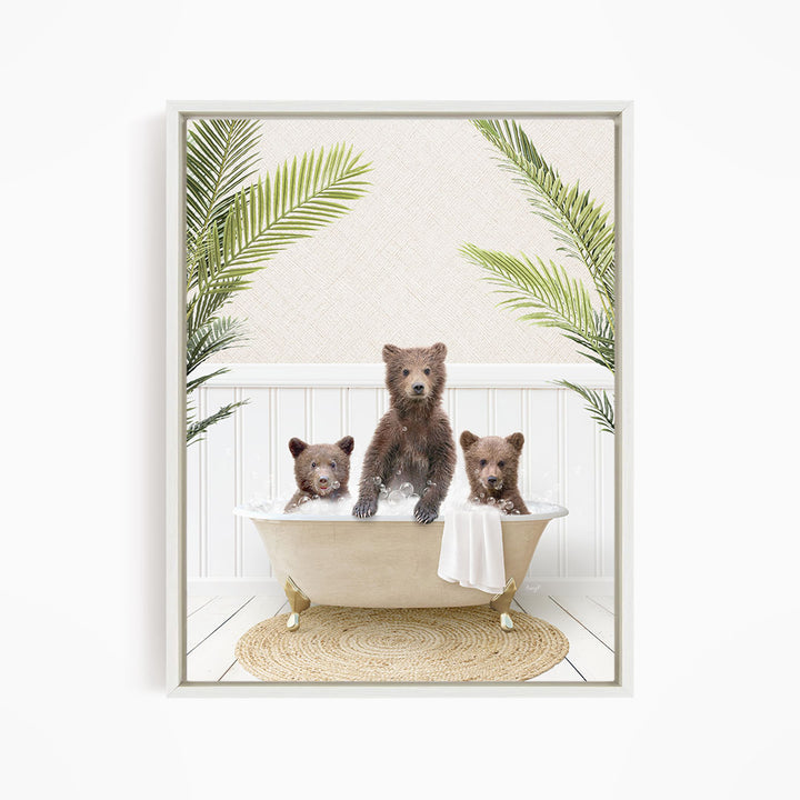 A framed image depicting three bears sitting in a bathtub, surrounded by palm leaves.