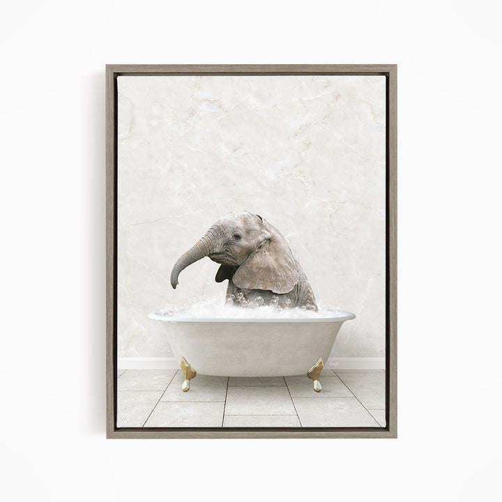 A baby elephant sitting in a white bathtub filled with water, with its trunk submerged in the water.