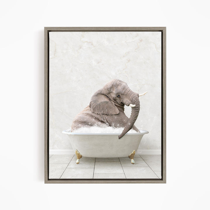 A gray elephant is sitting in a white bathtub, with its trunk raised and appearing to be enjoying the bath.