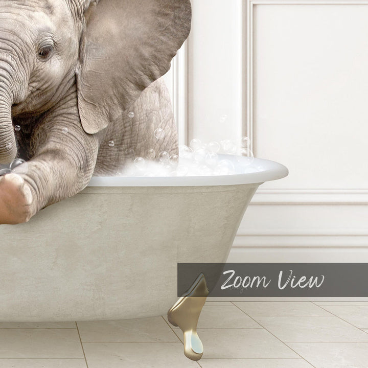 A baby elephant sitting in a bathtub filled with water, surrounded by bubbles.