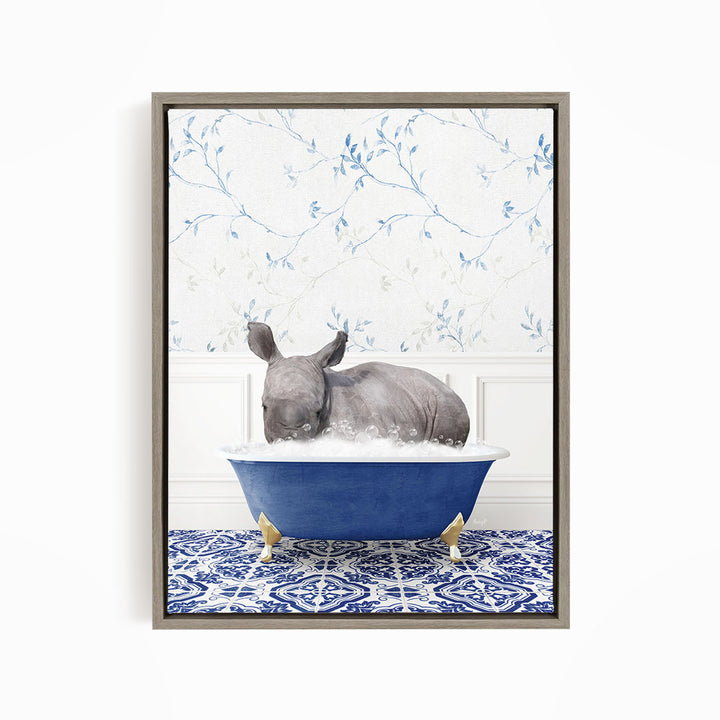 A rhinoceros is sitting in a blue bathtub filled with water, surrounded by a blue and white patterned floor.