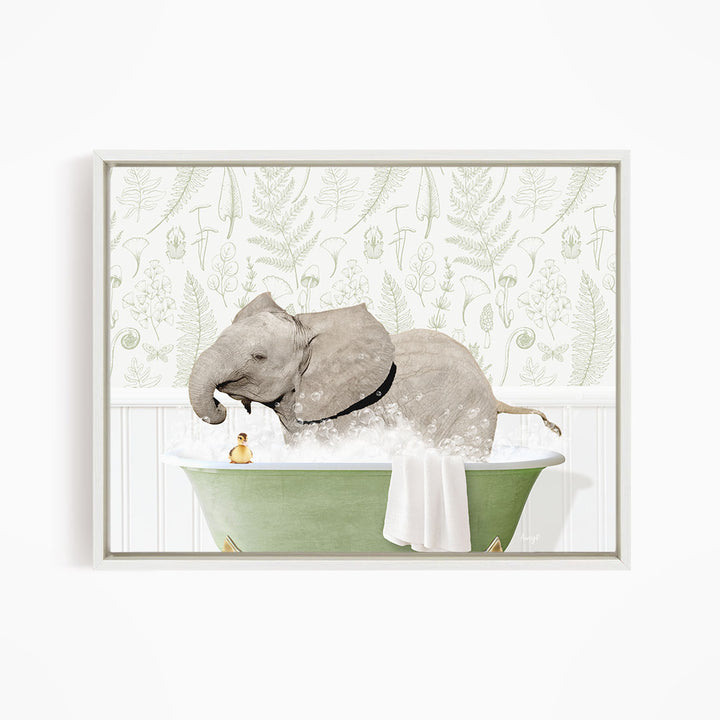 A gray elephant is sitting in a green bathtub filled with water, surrounded by a white towel and a small yellow rubber duck.
