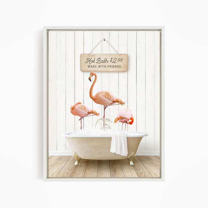 A framed image depicting three flamingos standing in a white bathtub, with a sign above them that reads "Hot Bath $2.00 WASH WITH FRIENDS".