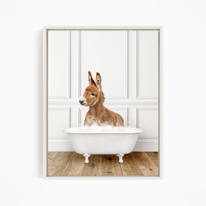 A donkey is sitting in a white bathtub filled with bubbles, creating a playful and whimsical scene.