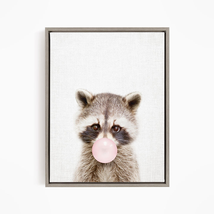 A raccoon blowing a bubble with a pink bubble gum bubble.