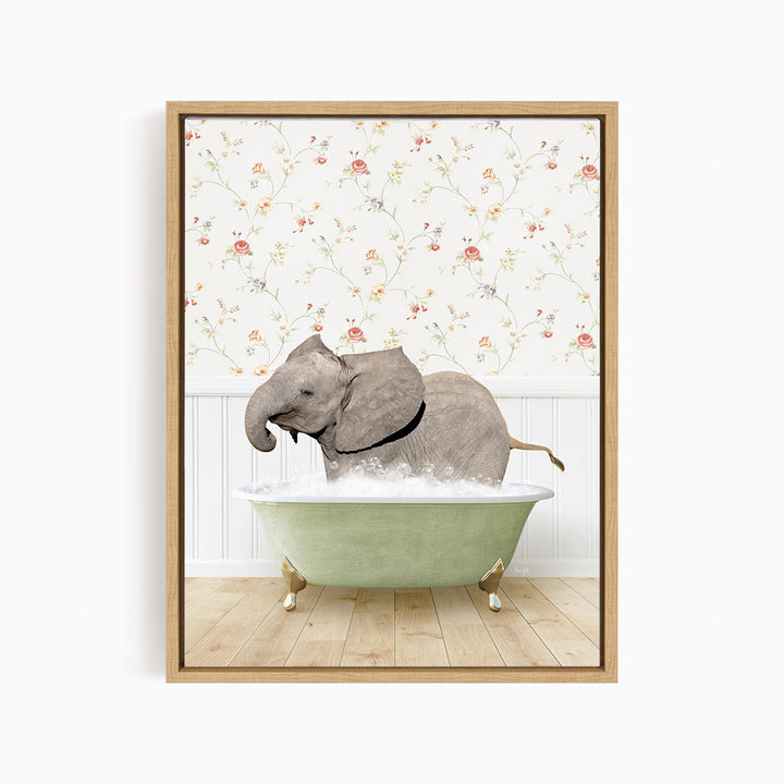 A gray elephant is sitting in a green bathtub filled with water, surrounded by a floral wallpaper.