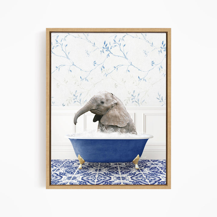 A baby elephant sitting in a blue bathtub filled with water, surrounded by a blue and white patterned rug.