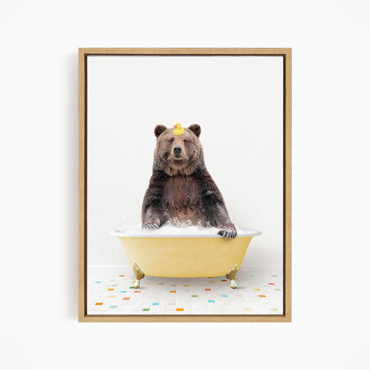 A brown bear sitting in a yellow bathtub filled with bubbles, with a yellow rubber duck on its head.